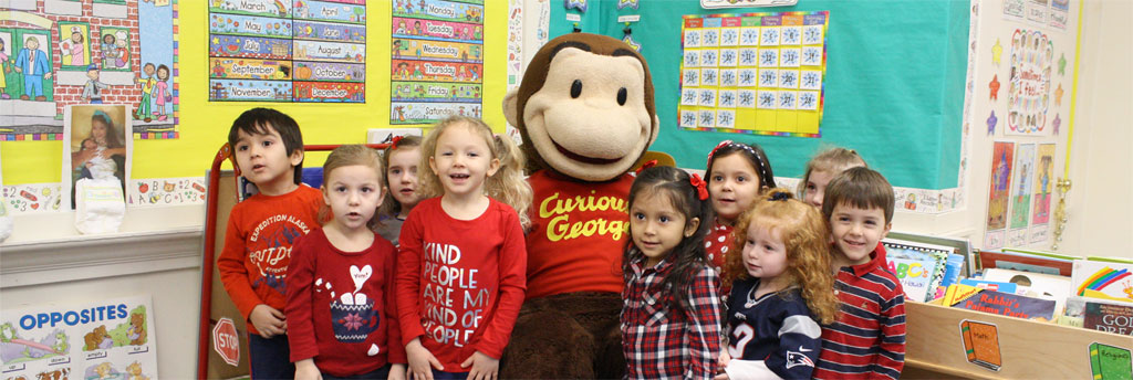 Reading with Curious George in Nursery School at Saint Michael